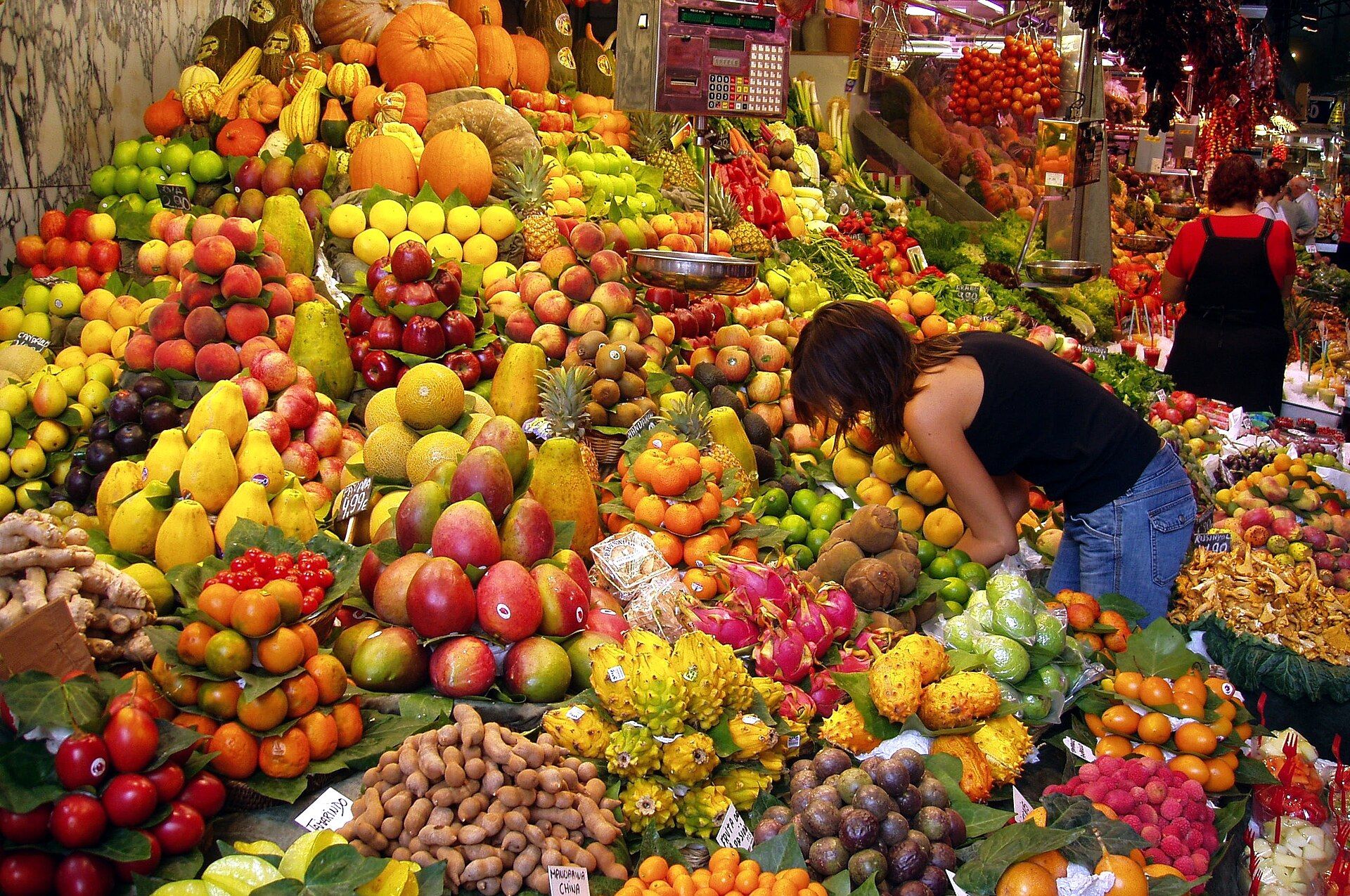 A colourful fruit stall piled high at a Barcelona market hall